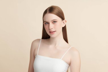 Güzel, genç bir Asyalı kadın, bej bir arka planda temiz, taze bir ten. Cilt bakımı, yüz bakımı, kozmetoloji, güzellik ve kaplıca. Asyalı bir kadının zarif bir portresi..