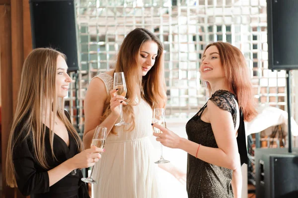 Portrait of smiling friends holding glass of champagne