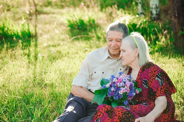 happy and very old people sitting in the park.