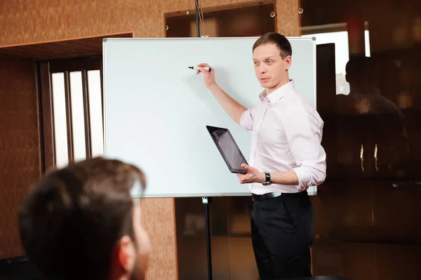 Businessman explaining business plan to coworkers in conference