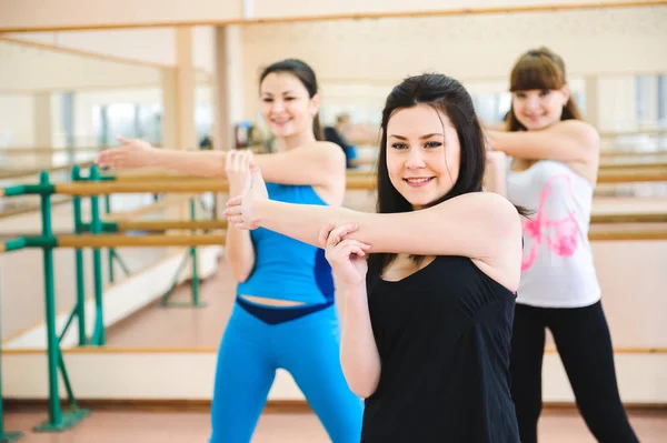 Group of people at the gym in a stretching class.