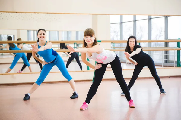 Group of people at the gym in a stretching class