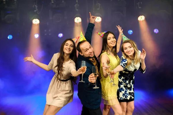 cheerful young company celebrates birthday in a nightclub