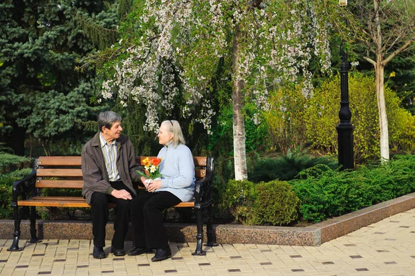 beautiful happy old people sitting in the spring park