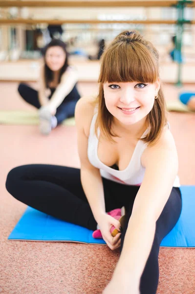 Group of people at the gym in a stretching class.