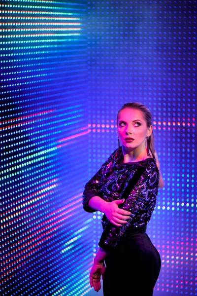 Model woman in neon light. Art design of female disco dancers posing in UV. Isolated on neon background.