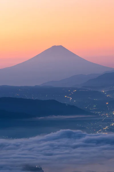 View of Mount Fuji and Sea of mist above Suwa lake in morning from Takabochi Highland, Mountain Takabochi, Nagano prefecture, Japan.