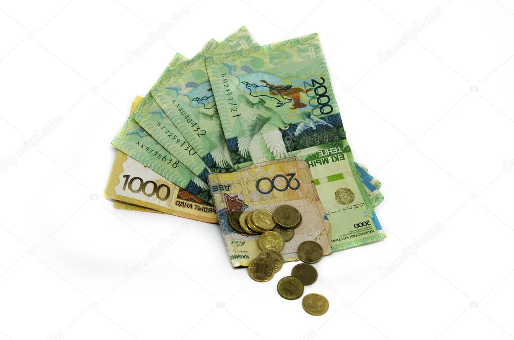 Coins on a white background. Coins Kazakhstan tenge on a white background. Kazakh money. Coins of tenge. large pile of coins and tenge paper banknotes