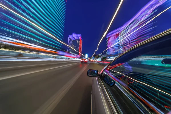 View from Side of Car moving in a night city