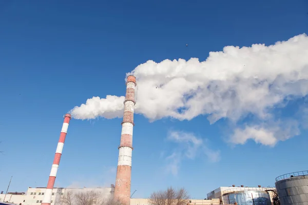 Smoke from the factory pipes. Ecological problem, mining enterprise with smoke stacks. Dirty smoke on the sky. Environmental issues. harmful emissions. Bad ecology. - Image