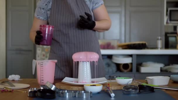 ハンドメイドケーキの上からピンクの光沢のある注ぎ ペストリーシェフは ミラー釉薬とモダンなフランスのムースデザートを準備します — ストック動画