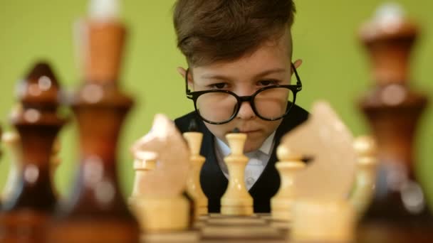 Child Playing Chess Table Little Boy Glasses Developing Chess Strategy — Stock Video