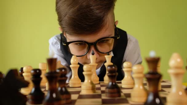 Child Playing Chess Table Little Boy Glasses Developing Chess Strategy — Stock Video