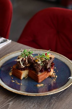 Kaz ciğeri ile kaplanmış kızarmış ekmeğin yakın çekim görüntüsü doku, renk ve gurme sunumu, mutfak ve yemek fotoğrafçılığı için mükemmel.