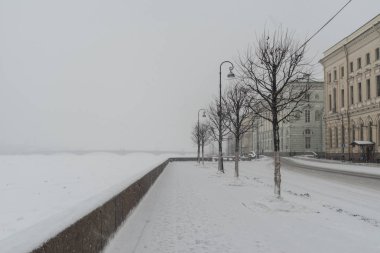Palace Embankment and Hermitage Bridge in snowfall. Winter  in St. Petersburg, Russia