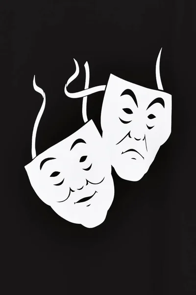 Two white theater masks a comedy and tragedy on a black background. The concept of theatrical art. Black and white. Isolate