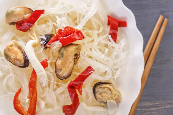 Traditional food in southeast Asia is rice noodles with seafood. Close-up. Top view