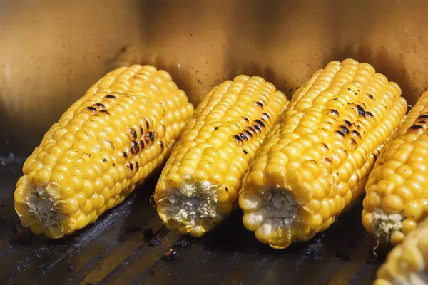 Grilled corn on the grill. Cooking food on the street