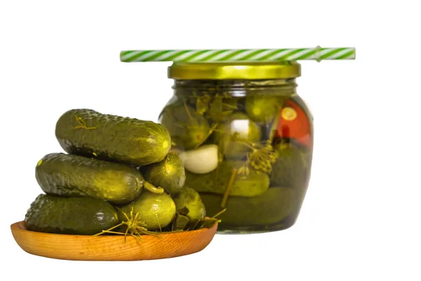 Cucumber pickle in a jar with a lid and a tube and pickled cucumbers in a plate. Isolated on white background — Stock Photo, Image