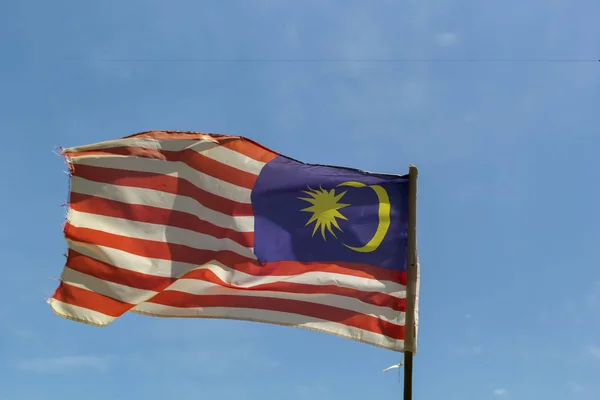 Flag of Malaysia fluttering in the wind against the blue sky with clouds — Stock Photo, Image