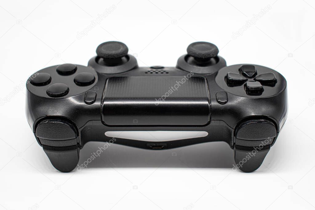 Black gaming controller, Joystick on white background, Isolated, Close-up, Front view.