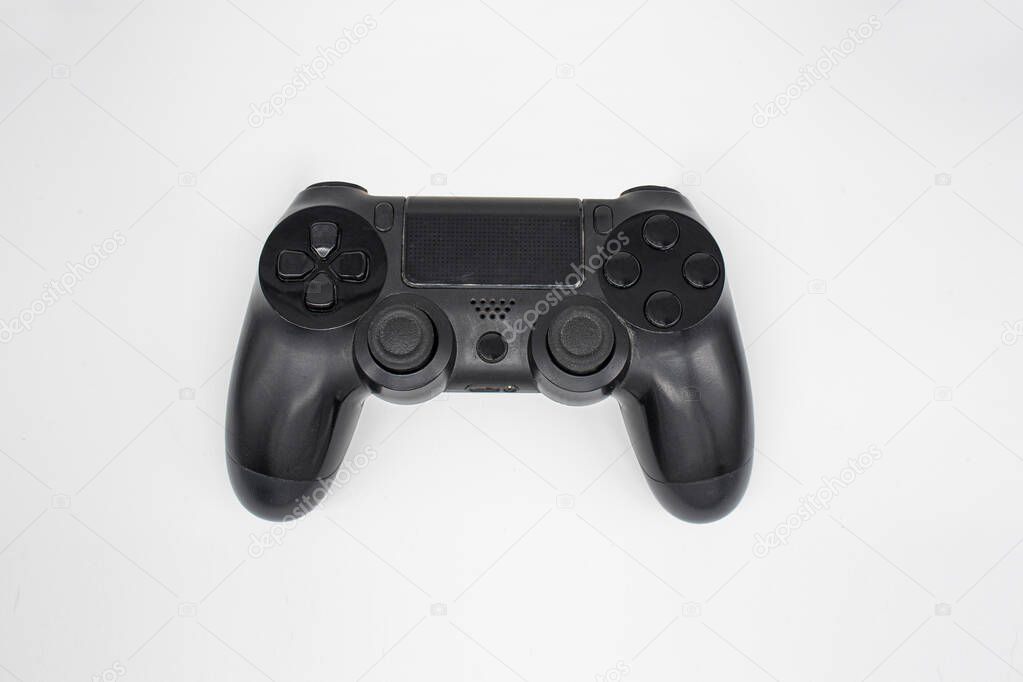 Black gaming controller, Joystick on white background, Isolated, Top view.
