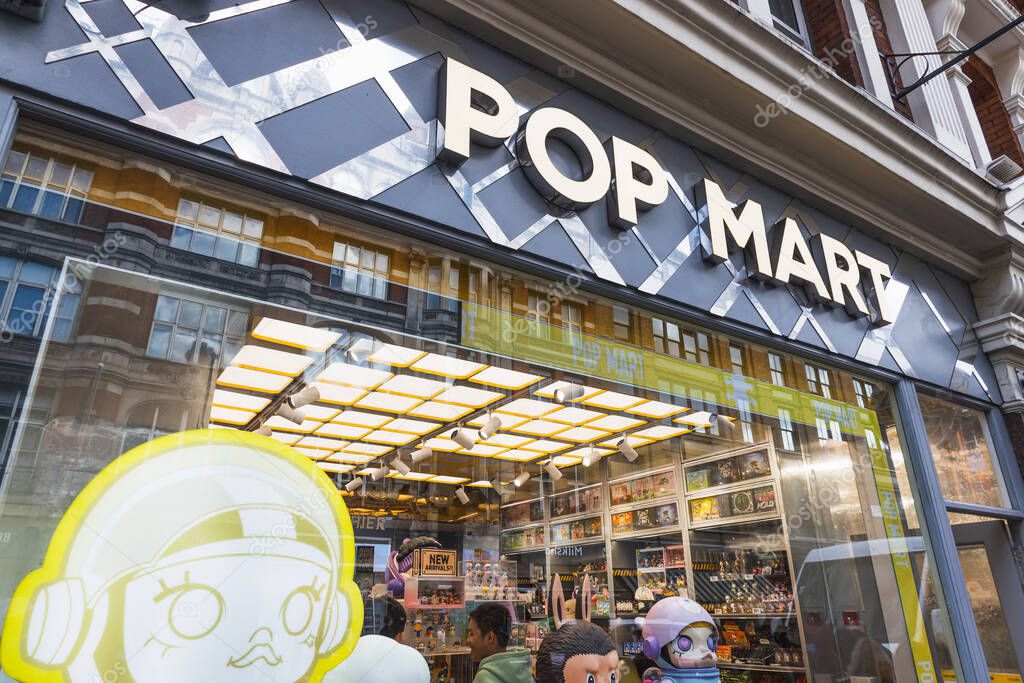 Wide view of Pop Mart store exterior with bright signage, window display, and shoppers browsing designer toy collectibles and blind box figures in an urban retail setting. London, UK, 5 October 2024