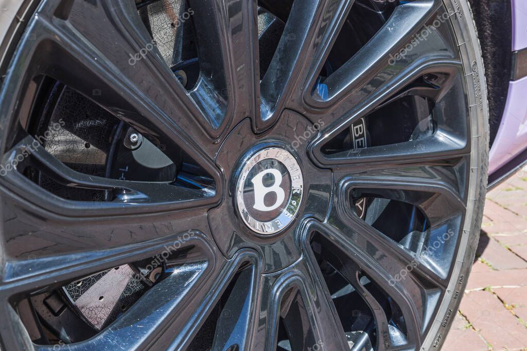 Detailed macro of a Bentley black alloy wheel with glossy spokes and logo. Vilnius, Lithuania, 2 July 2025