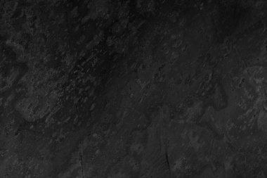 Yüzey ve derinlik gibi pürüzlü taşlar içeren kasvetli siyah grunge arkaplanı.