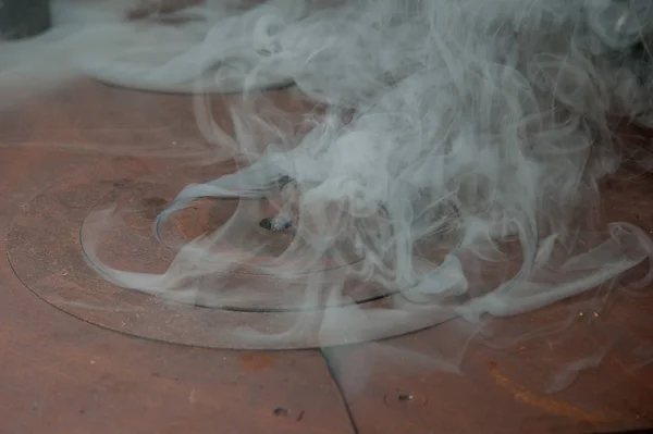 smoke coming out of an old wood stove