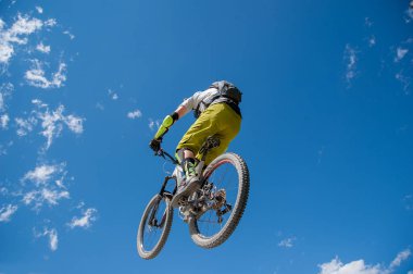 Livigno italy July 27th 2015:boy who finishes the descent by bike with a jump clipart