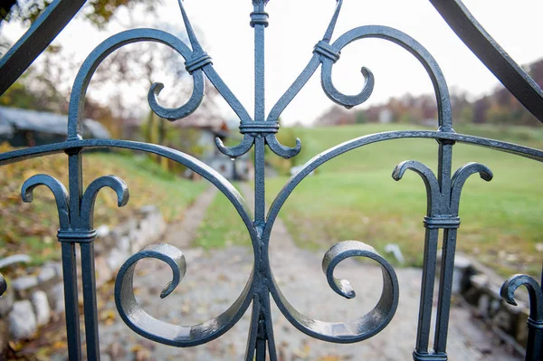 wrought iron gate with dew drops