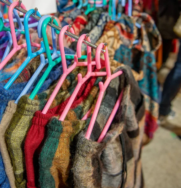 clothes hanging on colorful clothes hangers