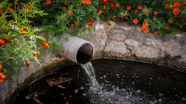 Waste water,drainage of water from a pipe into the river.Ecology pollution