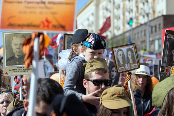 2018.09.05, Moscow, Russia. Victory Day in Moscow. Immortal regiment on Moscow street. Thousands march to remember World War 2 relatives. Boy in military uniform with festive balls.