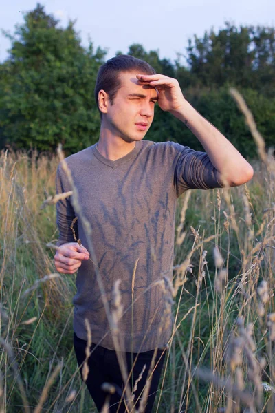 Young Handsome Thin Guy Looks Distance Standing Tall Grass — Stock Photo, Image