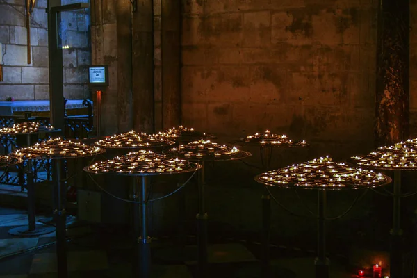 Interior of Cathedral with candles. Religious symbols in Notre Dame de Paris.