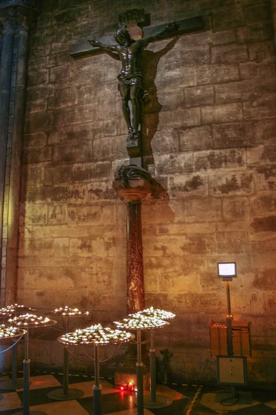 Interior of Cathedral with candles. Religious symbols in Notre Dame de Paris.