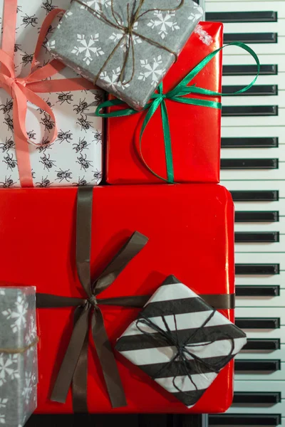Colorful present boxes on the piano. Christmas holidays decoration of Interior.