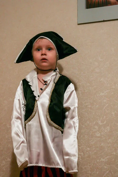 2010.11.28, Maloyaroslavets, Russia. A little boy wearing a pirate costume standing in the room. Carnival costume of cute kid, blurred and grain effect.