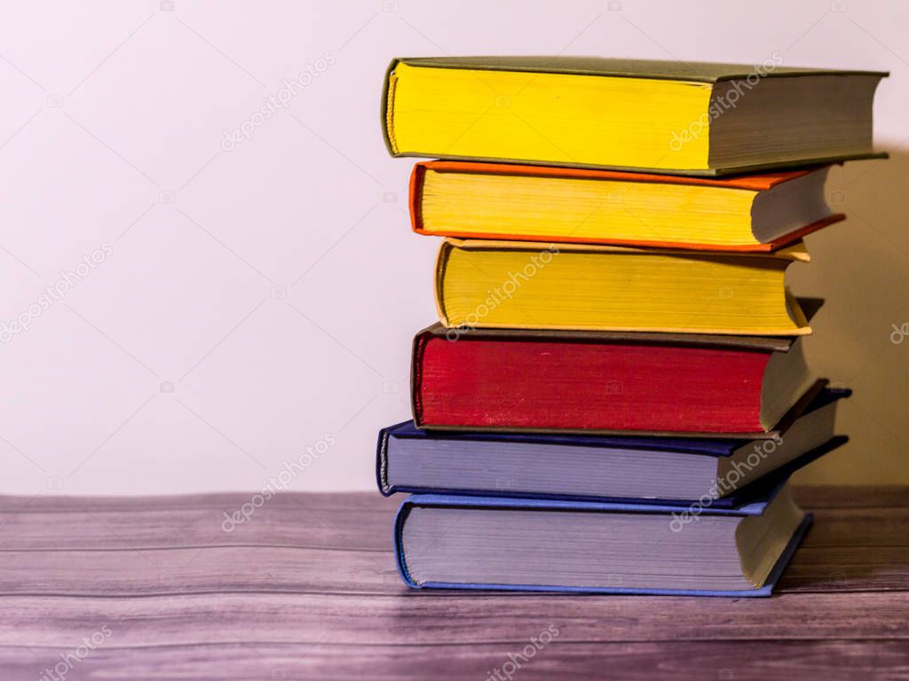 Concept of education and preparation for school. Split-level of colorful book stack on the white background. Knowledge is a power.