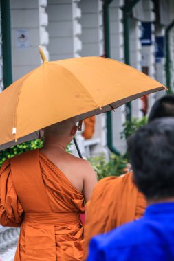 2011.05.16, Bangkok, Tayland. Grand Palace topraklarında dolaşan turistler gibi genç Budist rahipler. Asya'nın antik mimarisi. Bangkok Turistik Yerler. 
