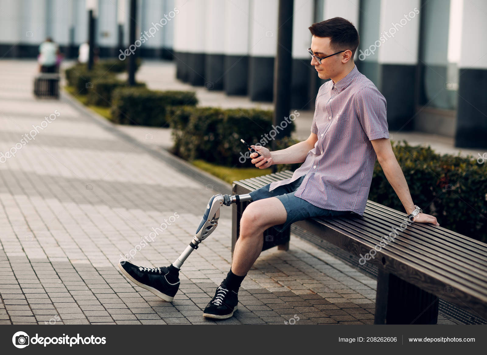 無効になっている若い男足を義足に座って 携帯電話を屋外に保持 ストック写真 C Atercorv Gmail Com