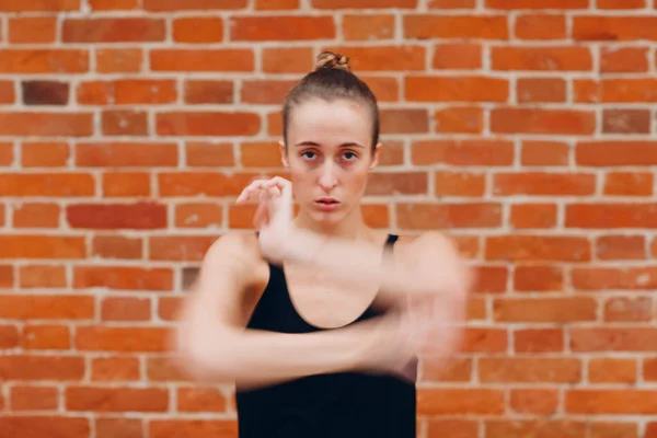 Young woman dancing contemporary in a dance studio