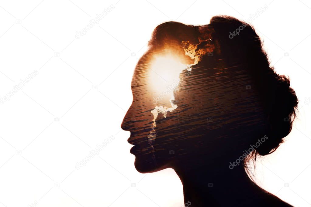 Multiple exposure portrait of a woman. The sun behind the clouds. Emotional intelligence concept.