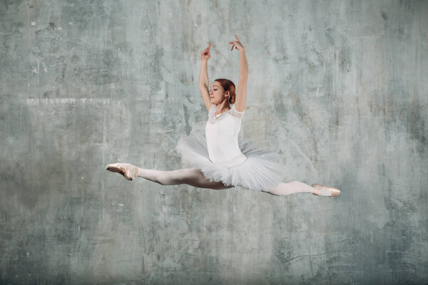 Ballerina female. Young beautiful woman ballet dancer, dressed in professional outfit, pointe shoes and white tutu.
