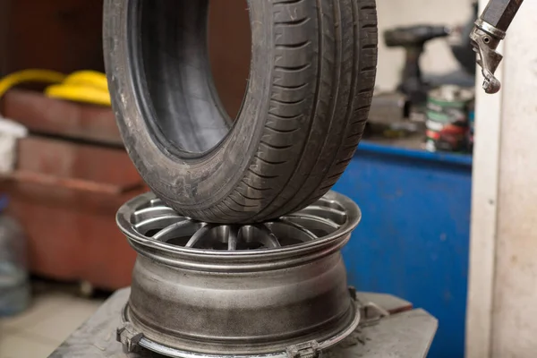 Meccanico cambio pneumatico auto montaggio. Riparazione degli pneumatici delle ruote. — Foto Stock