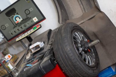 Wheel Balancing. Car wheel balance machine in auto repair