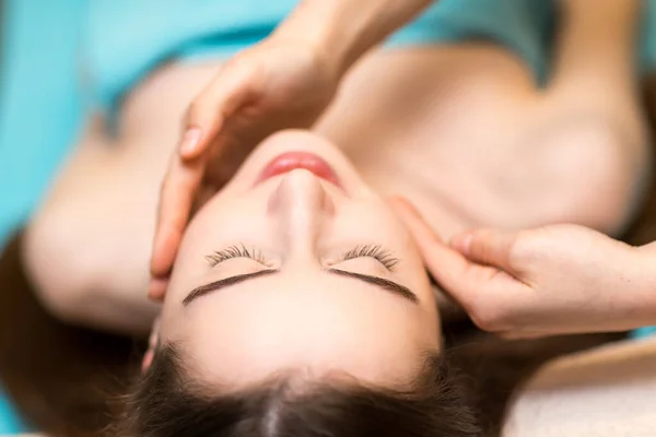 Young beautiful woman receiving head face massage in beauty spa — Stock Photo, Image