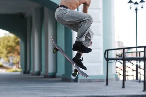 Giovane ragazzo pattinaggio trucco su skateboard in città — Foto Stock